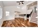 Open-concept living space with vaulted ceiling, wood floors, and staircase at 21743 Farmingdale Ct, Parker, CO 80138