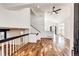 Bright living room with high ceilings, wood floors, and open floor plan showcasing stairs at 21743 Farmingdale Ct, Parker, CO 80138