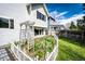 Well-maintained side yard with a flower garden and a charming white picket fence at 21743 Farmingdale Ct, Parker, CO 80138