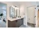 Bright bathroom featuring double sink vanity, modern lighting, and sleek black hardware at 10163 W 38Th Ave, Wheat Ridge, CO 80033
