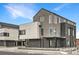Modern two-story home showcasing a sleek design and contrasting textures with ample windows and covered entry at 10163 W 38Th Ave, Wheat Ridge, CO 80033