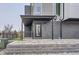 Modern home featuring a brick facade, covered entry and landscaped front yard at 10163 W 38Th Ave, Wheat Ridge, CO 80033