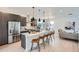 Open-concept kitchen features a large island with seating and stainless steel appliances at 10163 W 38Th Ave, Wheat Ridge, CO 80033