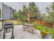 Relaxing backyard patio area with a dining set and grill, perfect for outdoor entertaining at 8657 Aberdeen Cir, Highlands Ranch, CO 80130