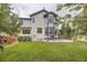 Expansive backyard with lush lawn, patio set, manicured landscaping, and a privacy fence at 8657 Aberdeen Cir, Highlands Ranch, CO 80130