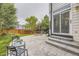 Backyard patio featuring outdoor seating, a stone patio, and access to the home at 8657 Aberdeen Cir, Highlands Ranch, CO 80130