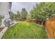 Lush backyard with a green lawn, wooden fence, patio, and an outdoor seating area at 8657 Aberdeen Cir, Highlands Ranch, CO 80130