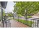 Inviting balcony with wood floors, metal railings, seating and neighborhood views at 8657 Aberdeen Cir, Highlands Ranch, CO 80130