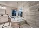 Modern bathroom featuring a soaking tub, glass shower, and updated vanity at 8657 Aberdeen Cir, Highlands Ranch, CO 80130