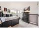 Comfortable bedroom with a large window, a dark wood dresser, and neutral decor create a serene retreat at 8657 Aberdeen Cir, Highlands Ranch, CO 80130