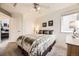 Bright bedroom featuring neutral tones, a ceiling fan, and a comfortable bed at 8657 Aberdeen Cir, Highlands Ranch, CO 80130