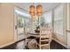 Cozy breakfast nook with a round table, pendant lights, and sliding door to outdoor patio at 8657 Aberdeen Cir, Highlands Ranch, CO 80130