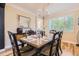 Formal dining room with shuttered windows, wood floors, chandelier, and wooden table with seating for six at 8657 Aberdeen Cir, Highlands Ranch, CO 80130