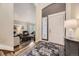 Inviting entryway with hardwood floors, a decorative rug, and views into the living room at 8657 Aberdeen Cir, Highlands Ranch, CO 80130