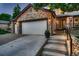 Stone-accented home with a two-car garage and well-lit entryway at 8657 Aberdeen Cir, Highlands Ranch, CO 80130