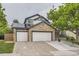 Charming home featuring stone accents, three-car garage, and solar panels at 8657 Aberdeen Cir, Highlands Ranch, CO 80130