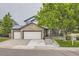 Charming home featuring stone accents, three-car garage, and inviting curb appeal at 8657 Aberdeen Cir, Highlands Ranch, CO 80130