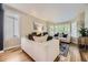 Bright living room with hardwood floors, neutral tones and large windows at 8657 Aberdeen Cir, Highlands Ranch, CO 80130
