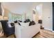 Bright living room with hardwood floors, bay window, and comfortable seating area at 8657 Aberdeen Cir, Highlands Ranch, CO 80130