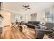 Bright living room with hardwood floors, modern furniture, and large windows with natural light at 8657 Aberdeen Cir, Highlands Ranch, CO 80130
