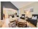 Elegant living room with hardwood floors, vaulted ceiling, and seamless flow to dining area at 8657 Aberdeen Cir, Highlands Ranch, CO 80130