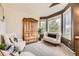 Bright sitting room with large windows, arm chairs, and natural wood accents at 8657 Aberdeen Cir, Highlands Ranch, CO 80130
