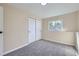This carpeted bedroom includes a closet and a window offering natural light and views at 1880 E 81St Pl, Denver, CO 80229