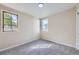This bedroom has two bright windows and neutral carpeting, creating a cozy and inviting space at 1880 E 81St Pl, Denver, CO 80229