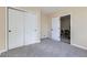 The carpeted bedroom has a closet and a view into a dining room, offering flexibility at 1880 E 81St Pl, Denver, CO 80229