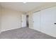 The carpeted bedroom has a double closet for great storage; doorway leads to another room at 1880 E 81St Pl, Denver, CO 80229