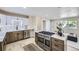 Beautiful kitchen featuring updated cabinets, stainless steel appliances, and a large island with gas cooktop at 1880 E 81St Pl, Denver, CO 80229