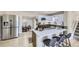 Modern kitchen with stainless steel appliances, white cabinets and quartz counters with center island cooktop at 1880 E 81St Pl, Denver, CO 80229