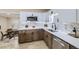 Updated kitchen with stainless steel appliances, quartz counters, stylish tile backsplash and light wood floors at 1880 E 81St Pl, Denver, CO 80229