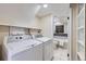 Laundry room with two machines and a bathroom with tub in view at 1880 E 81St Pl, Denver, CO 80229