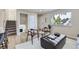 Cozy living area with contemporary furnishings, neutral paint, light wood floors, and a view of the outdoors at 1880 E 81St Pl, Denver, CO 80229
