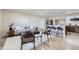 Bright living room with modern furniture, light wood floors, and a view into the updated kitchen at 1880 E 81St Pl, Denver, CO 80229