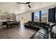 Open concept living room and dining area featuring modern lighting and luxury vinyl plank flooring at 760 N Allium St, Watkins, CO 80137