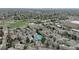 Panoramic aerial view highlighting community amenities, with tennis courts, and nearby waterways at 5875 W Asbury Pl, Lakewood, CO 80227