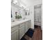 Bathroom featuring a double sink vanity with modern fixtures, tile floors, and a walk-in shower at 5875 W Asbury Pl, Lakewood, CO 80227