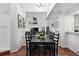 Open concept dining room has a dark wood table, seating for six, and wood floors at 5875 W Asbury Pl, Lakewood, CO 80227