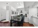Elegant dining room with ample seating and a modern chandelier, perfect for hosting gatherings at 5875 W Asbury Pl, Lakewood, CO 80227