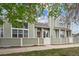 Charming townhome with large windows and a well-maintained front exterior at 5875 W Asbury Pl, Lakewood, CO 80227