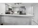 Kitchen with stainless steel appliances, a breakfast bar, white countertops, and shaker cabinets at 5875 W Asbury Pl, Lakewood, CO 80227