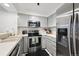 Kitchen has stainless steel appliances, white counter tops and white shaker cabinets at 5875 W Asbury Pl, Lakewood, CO 80227