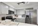 Bright kitchen with stainless steel appliances, white counters, and shaker style cabinets at 5875 W Asbury Pl, Lakewood, CO 80227