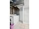 Functional laundry room showcasing modern washer, dryer, and ample shelving space for storage at 5875 W Asbury Pl, Lakewood, CO 80227