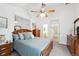 Bright main bedroom featuring a ceiling fan, neutral walls, and an ensuite bathroom at 5875 W Asbury Pl, Lakewood, CO 80227