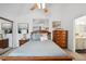 Bright main bedroom featuring a ceiling fan, neutral walls, and an ensuite bathroom at 5875 W Asbury Pl, Lakewood, CO 80227