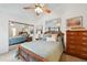 Bright main bedroom featuring a ceiling fan, closet with mirrored doors, and modern decor at 5875 W Asbury Pl, Lakewood, CO 80227