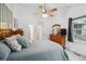 Bright main bedroom featuring a ceiling fan, neutral walls, and an ensuite bathroom at 5875 W Asbury Pl, Lakewood, CO 80227